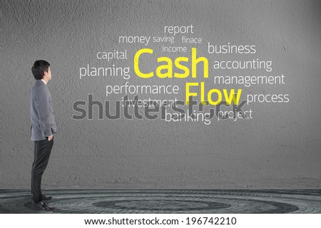 Businessman looking Cash Flow text wording in cloud concept