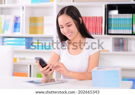 Asian student happy with online learning study by E-learning content technology with Mobile phone and Computer tablet