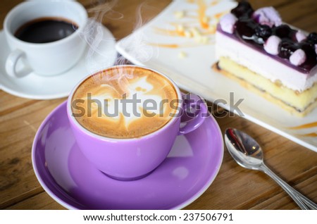 coffee late art on table with blueberry cake