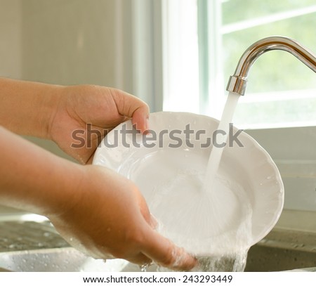 Close up Hand cleaning dish in kitchen room