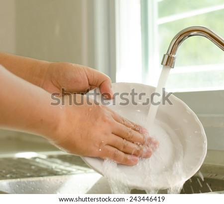 Male hand cleaning dish