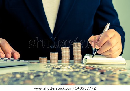 Investment concept by businessman record money value to paper note