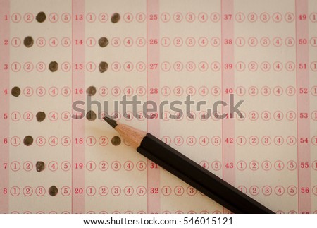 Close up pencil drawing selected choice on answer sheets
