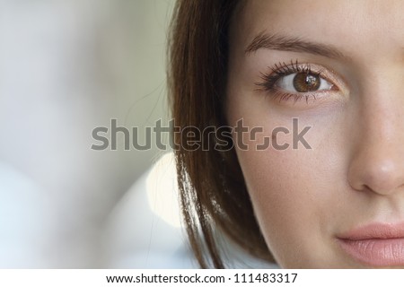 Half of the girl\'s face with brown eyes