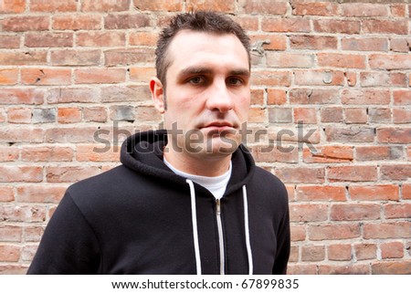 A man wears a stylish black sweatshirt for an edgy alternative photo shoot in Oregon.