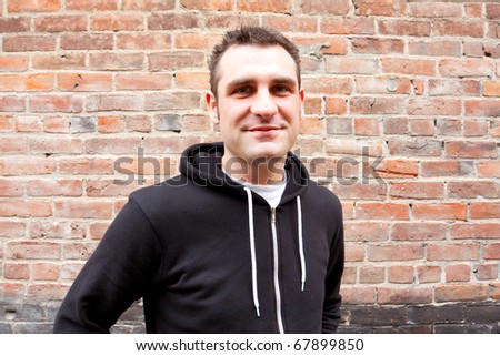 A man wears a stylish black sweatshirt for an edgy alternative photo shoot in Oregon.