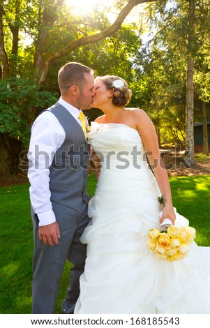 A bride and groom pose for a casual portrait on their wedding day outdoors in the summer in oregon.