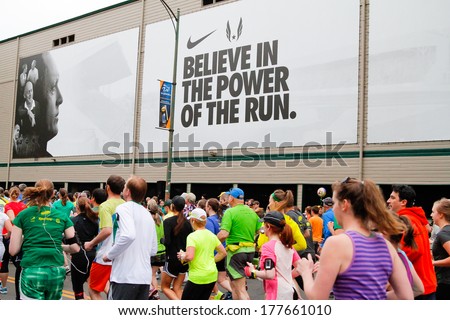 Eugene, OR - April 28: 2013 Eugene Marathon start with runners next to Historic Hayward Field at the University of Oregon with a Nike advertisement in the background on April 28, 2013 in Eugene, OR.