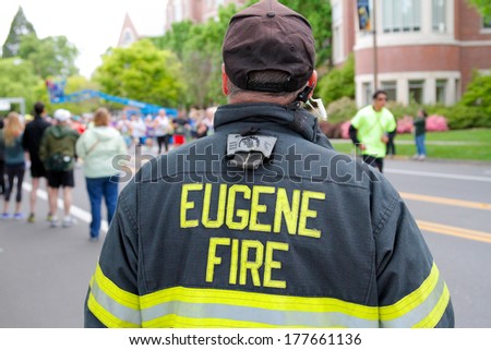 EUGENE, OR - April 28: Eugene Fire marshall looks on as runner start the Eugene Marathon on April 28, 2013 in Eugene, OR. The Eugene Marathon is a premier marathon in the U.S.