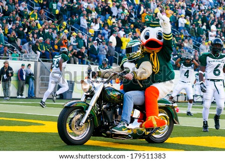 EUGENE, OR - OCTOBER 28, 2006: Oregon duck, Puddles, rides onto the field on the back of a Harley Davidson motorcycle at the UO vs PSU football game at Autzen Stadium.
