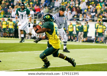 EUGENE, OR - OCTOBER 28, 2006: Oregon running back Jeremiah Johnson carries the ball during the UO vs PSU football game at Autzen Stadium.