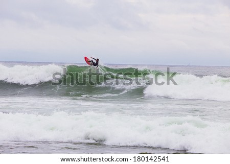 LA JOLLA, CA - JANUARY 30, 2014: Unknown surfer catching air while surfing a big wave in La Jolla California.