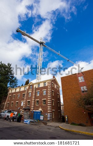 EUGENE, OR - MARCH 4, 2014: Building construction on the University of Oregon campus with a crane extending into the sky.