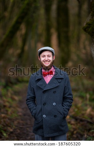 Trendy hipster guy outdoors in the winter in a fashion portrait of the handsome man.
