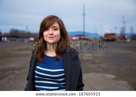 Modern, trendy, hipster girl in an abandoned train yard at dusk in this fashion style portrait.