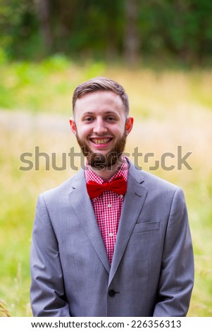 Fashionable groom on his wedding day outdoors just before the ceremony.