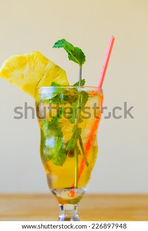 Mojito with mint in a traditional mixed drink glass served with a straw at a Mexican restaurant bar.