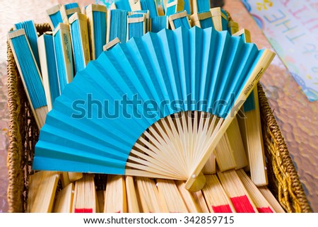 BATTLE GROUND, WA - JULY 19, 2014: Blue fans at a wedding ceremony for the guests to use in extremely hot weather.