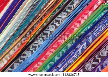 Linens in various patterns, angles and of colors on display at the outdoor craft market in Otavalo, Ecuador