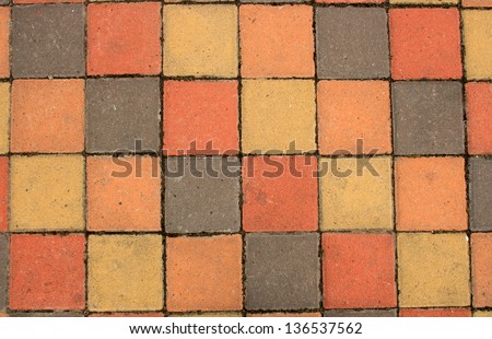 Colorful square paving tiles in a sidewalk in Cotacachi, Ecuador