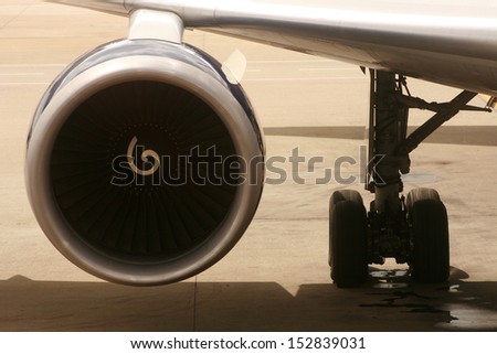 A jet engine and landing gear on an airplane on a runway in Atlanta, Georgia, USA