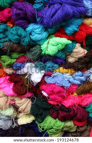 Balls of wool in a variety of colors for sale at the outdoor craft market in Otavalo, Ecuador