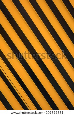 Yellow and black stripes painted on a steel door in Otavalo, Ecuador