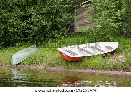 Boats and a wooden house near the lake in Finland