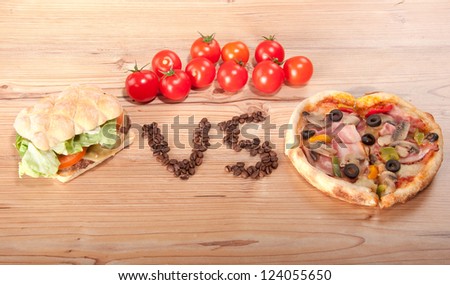 tasty hamburger and pizza. versus. vs. and some tomatoes.