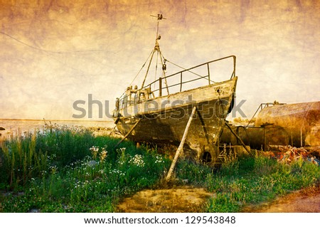 Old rusty boat at seashore with green grass. old style photo