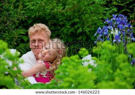 happy father and little girl at a garden.