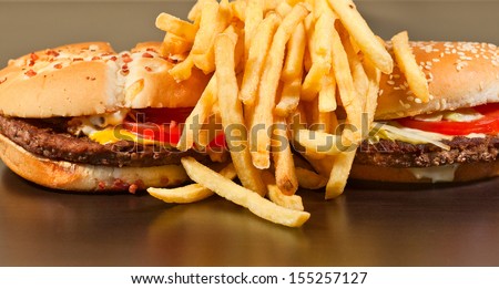 fast food set big hamburger and french fries on black background