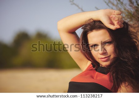 Girl going for a walk in-field and on sand. Beauty and calmness.