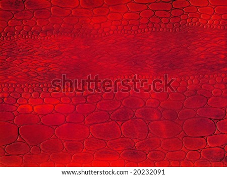 Close-up red natural reptile leather texture to background