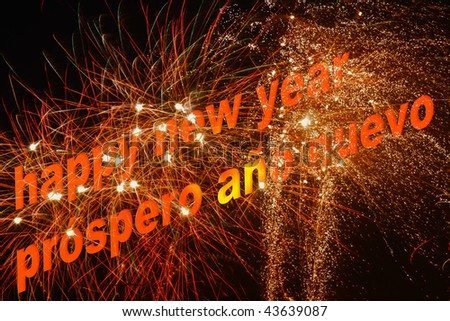 \'Happy new year\' written in English and Spanish with a spectacular firework in the background