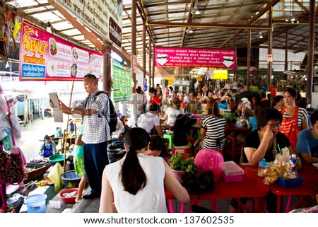 RATCHABURI, THAILAND - MAY 2: Locals travel on rowing boats, selling products at Damnoen Saduak Floating Market on May 2, 2013 in Ratchburi, Thailand. The market is one of tourist spots in Thailand