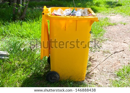 Yellow garbage bin
