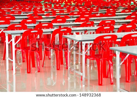 Red chairs arranged in  and white desk