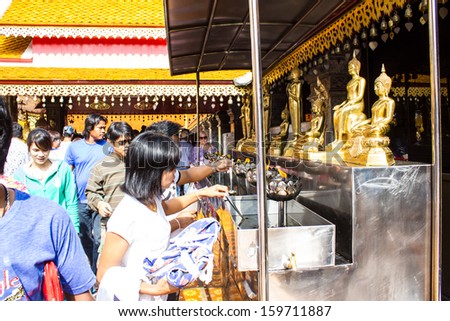 CHIANGMAI - OCTOBER 14:Tourists come to pray at the Doi Suthep Temple in Chiang Mai, Thailand on October 14, 2013. The temple founded in 1385 is a major tourist attraction in Chiang Mai.