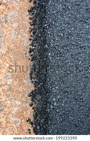 Rock and soil material on the new paved road