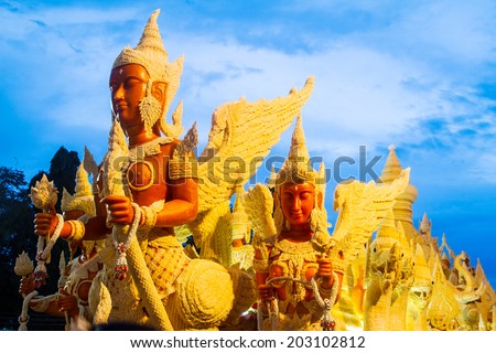 UBONRATCHATHANI, THAILAND - JULY 23: Candles are carved out of wax, Thai art form of wax(Ubon Candle Festival 2013) on July 23, 2013, UbonRatchathani, Thailand