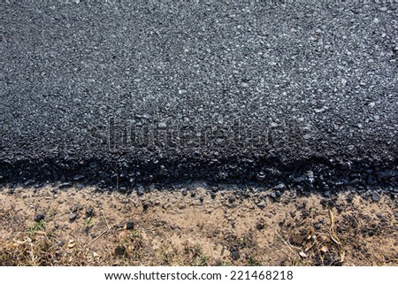 Rock and soil material on the new paved road