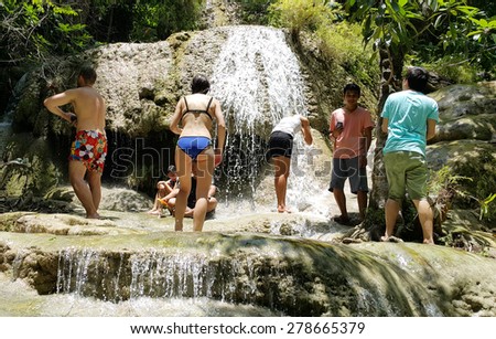 KANCHANABURi, THAILAND - APRIL 30, 2015: People have fun on the waterfall on April 30, 2015 in Arawan Waterfall The Arawan Waterfall is one of beautiful waterfall in Kanchanaburi Thailand.