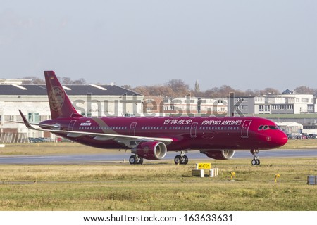 HAMBURG, GERMANY - NOVEMBER 13, 2013: A brand new Airbus A321 for chinese Juneao Airlines taxiing on the Airbus plant in Hamburg Finkenwerder on NOVEMBER 13, 2013.