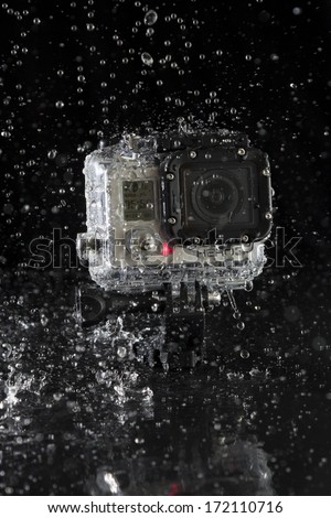 Hamburg, Germany - January 17: A Gopro Hero 3 Action-Cam In The Waterproof Case With Splashing Water On Black Background On January 17, 2013 In Hamburg