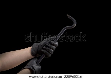 A Hand in black leather gloves holding a cow bar