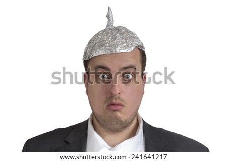 distraught looking conspiracy believer in suit with aluminum foil head isolated on white background