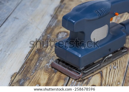 blue grinding machine on rustic wooden surface