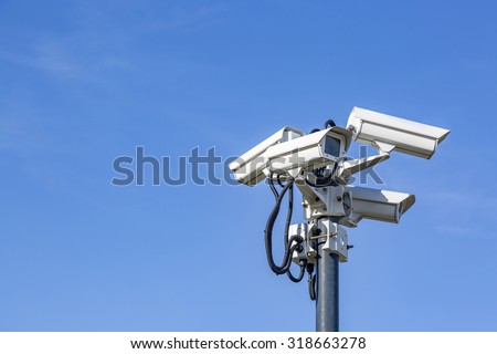Four CCTV surveillance cameras on a pole