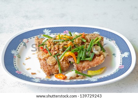 a photo of fried pickled fish with spicy herb,thai tradition food